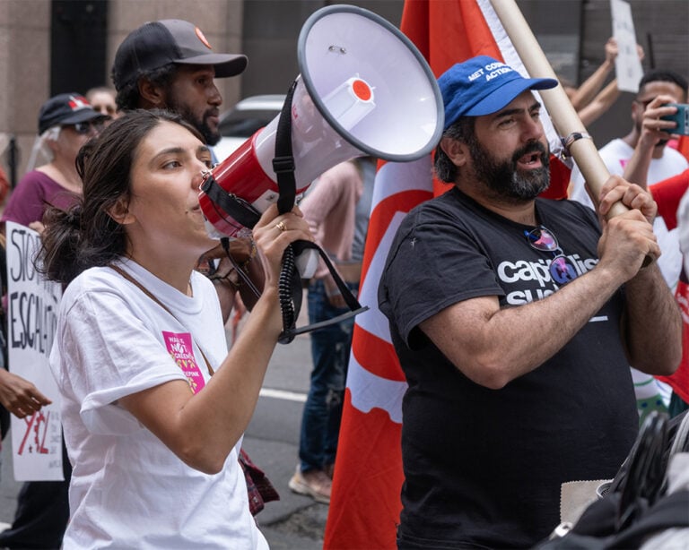 A woman shouts through a megaphone at the March to End Fossil Fuels in New York, September 2023