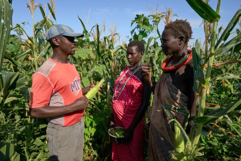An agricultural specialist advises two women farmers in Karukochom, South Sudan