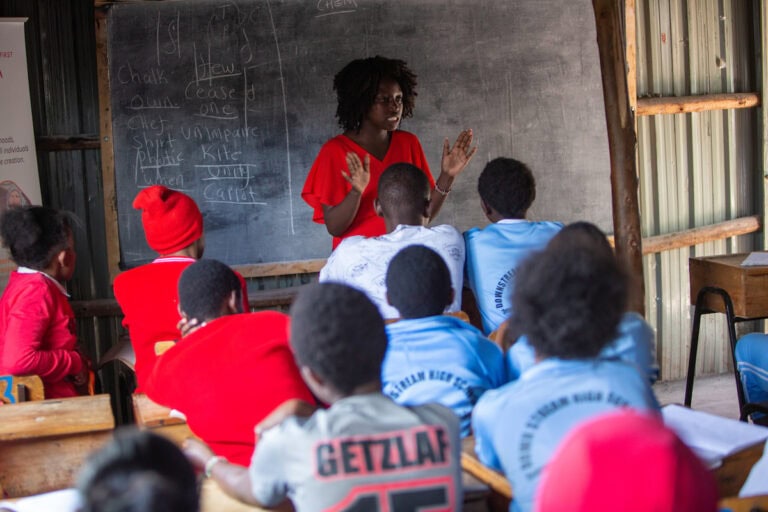 A teacher giving a class to students in Kenya